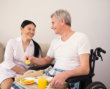 caregiver giving food to a senior patient